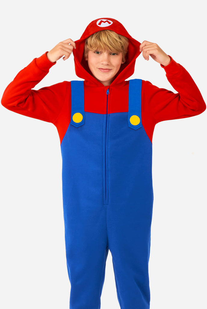 Boy wearing kids onesie with Super Mario print.