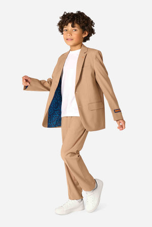 Een kind in een stijlvol lichtbruin/beige pak met een wit overhemd, wegkijkend van de camera. Perfecte formele outfit voor speciale gelegenheden, bruiloften en feestjes voor jongens.