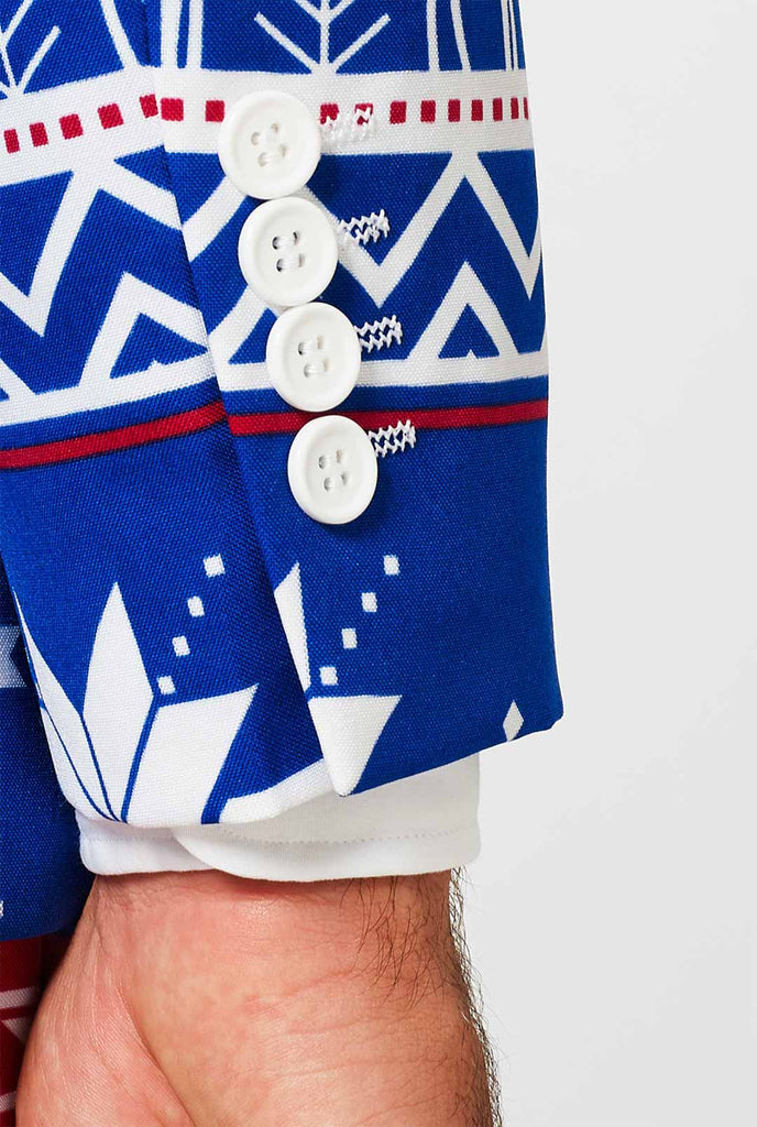 Man draagt ​​een blauw kerstpak met een van de Noordse thema -print, mouw close -up