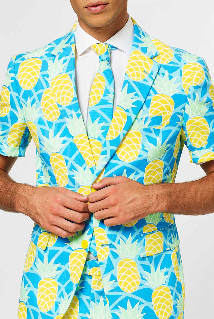 Man draagt ​​een blauw zomerpak met ananasafdruk, close -up