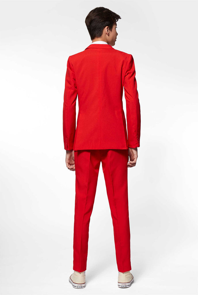 Tiener draagt ​​rood formeel pak, bekijk vanaf de achterkant