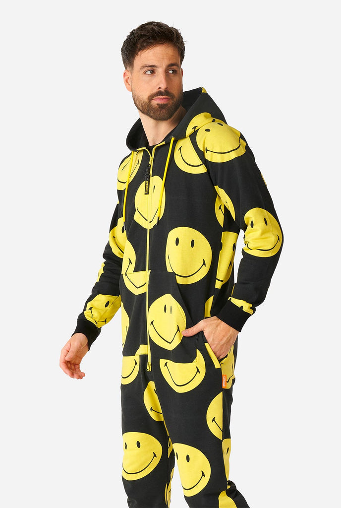 Man draagt ​​zwarte onesie met gele smiley print