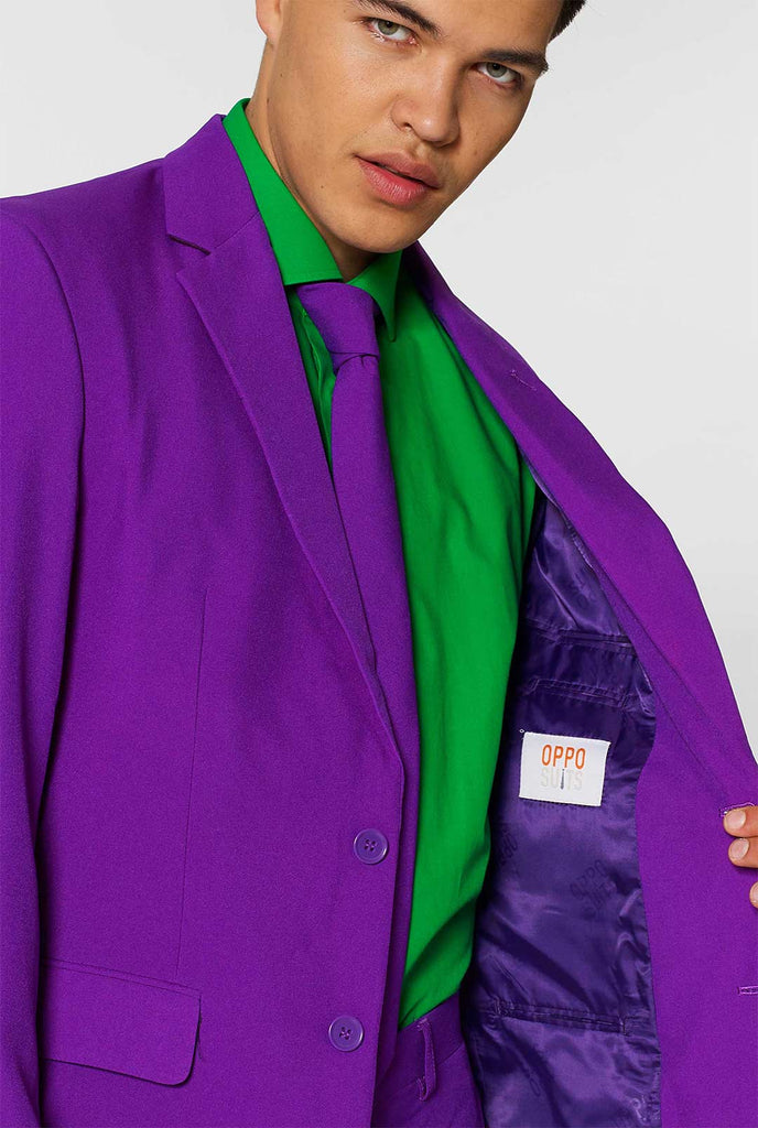 Man wearing purple men's suit and green dress shirt