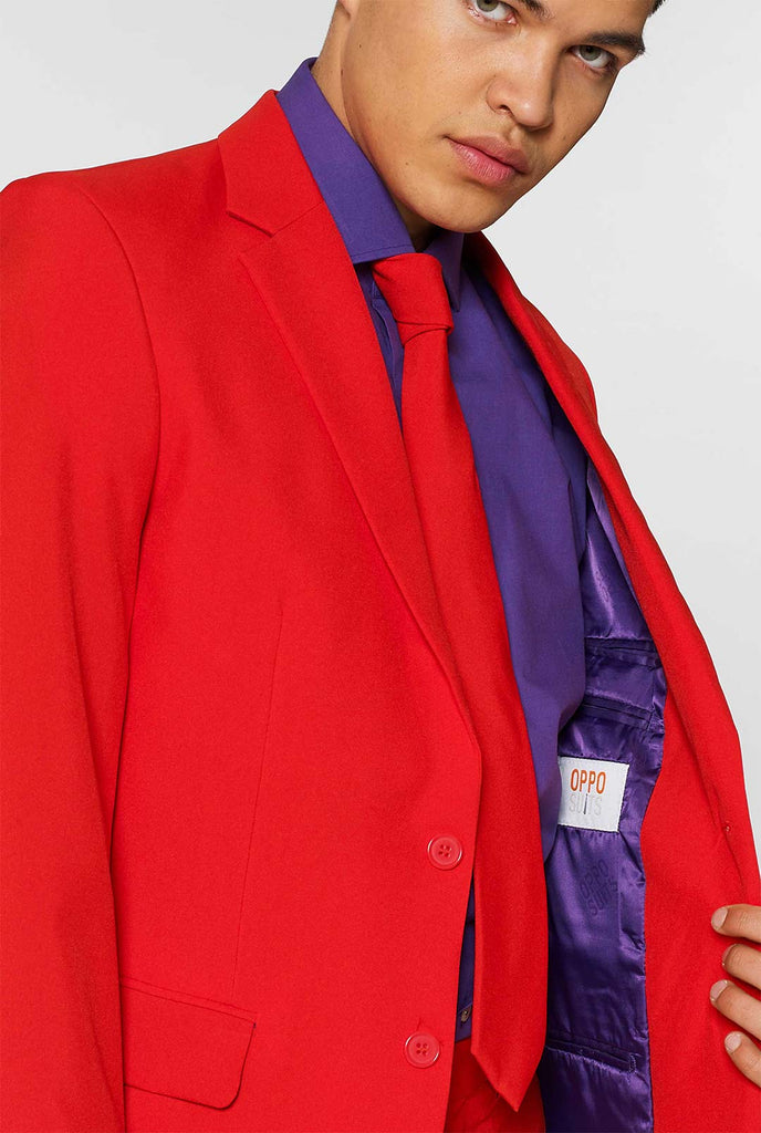 Man wearing red men's suit with purple dress shirt