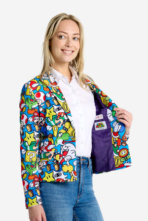 Vrouw draagt ​​een all-over print Super Mario blazer met iconische Super Mario karakters. De basis is lichtblauw, maar er is ook geel, rood en wit.