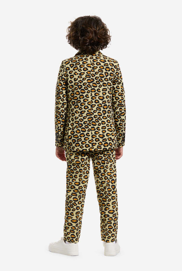 Op deze afbeelding draagt ​​een kind een jongenspak met all-over panterprint en een wit shirt. Het pak is beige met bruine en zwarte gevlekte panterprint. Pakken bestaan ​​uit een jasje, broek en clip-on stropdas. Beeld van de achterkant.