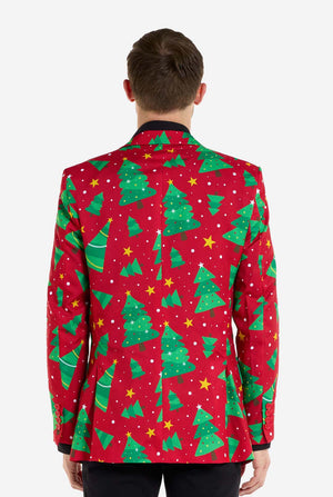 Man met rode kerstblazer voor heren met kerstbomen en sterrenprint. Man draagt ​​ook een zwarte broek en een zwart herenoverhemd. Uitzicht vanaf de achterkant.