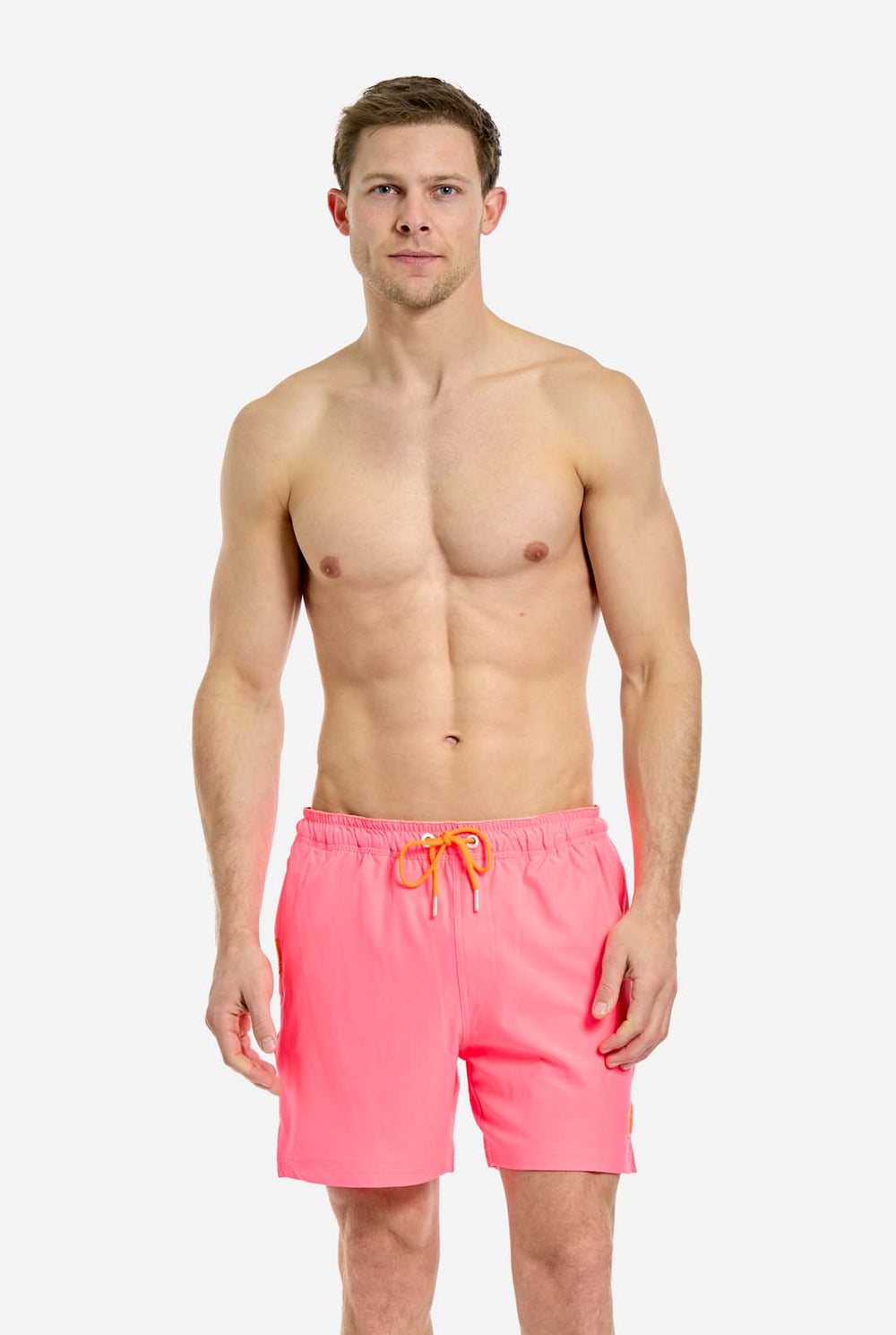 Man wearing Neon Pink Power swim trunks for men, close up