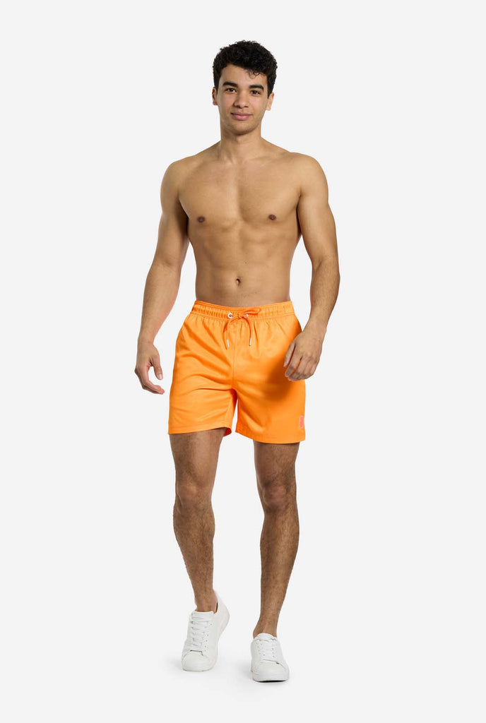 Man wearing Neon Vivid Orange swim trunks for men