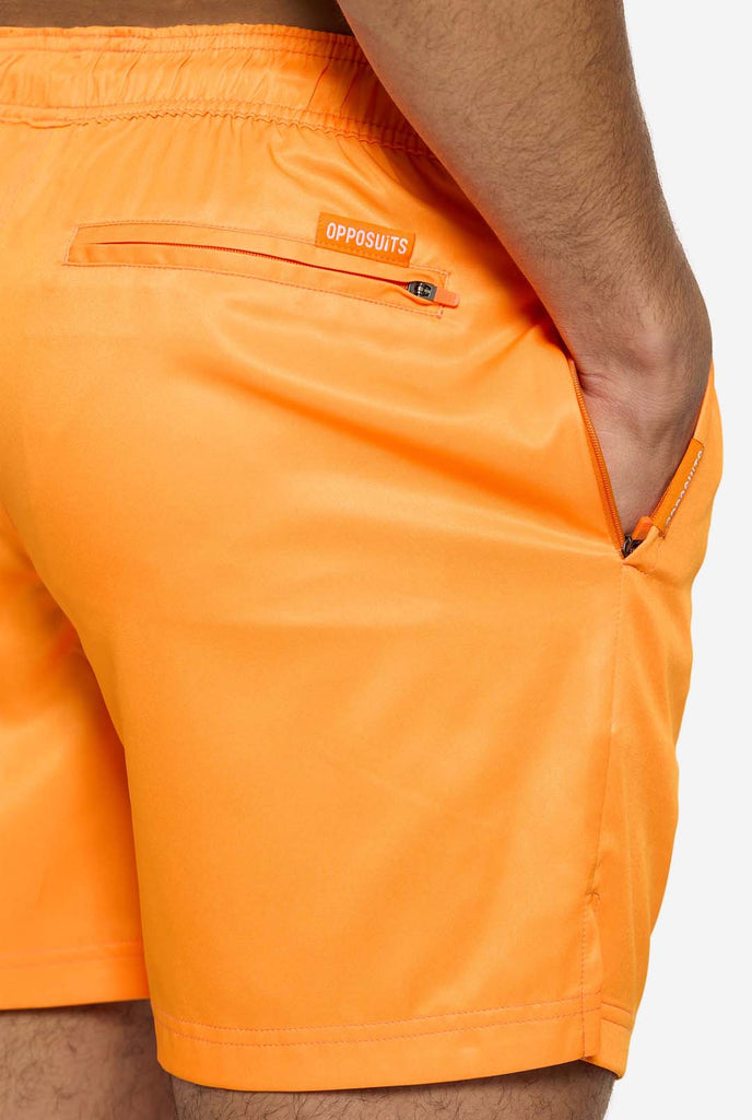 Man wearing Neon Vivid Orange swim trunks for men, close up