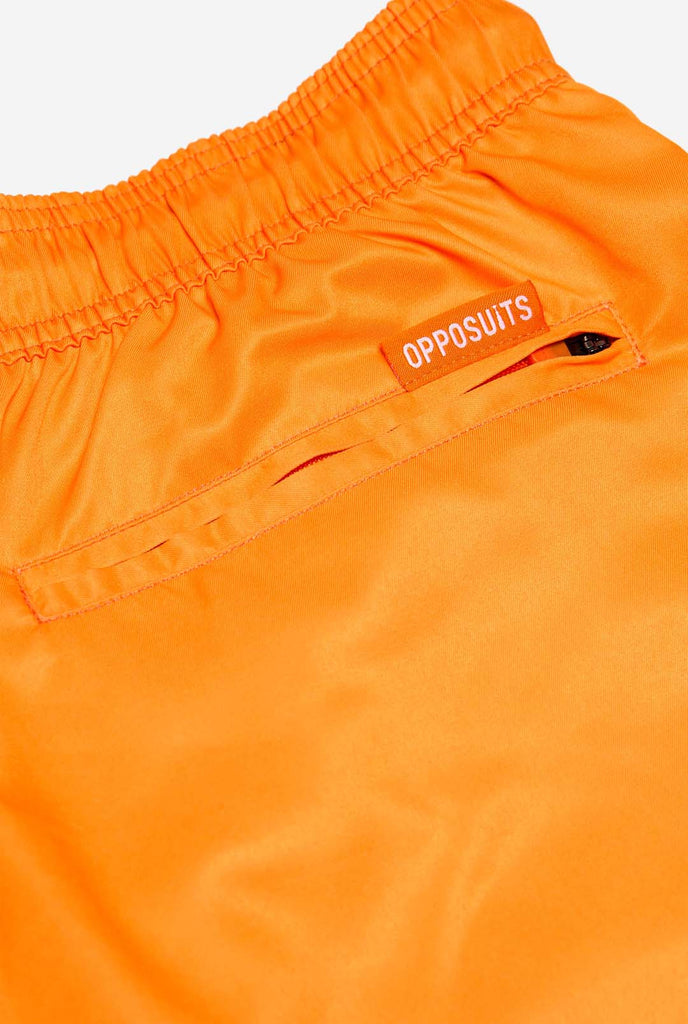 Man wearing Neon Vivid Orange swim trunks for men, close up