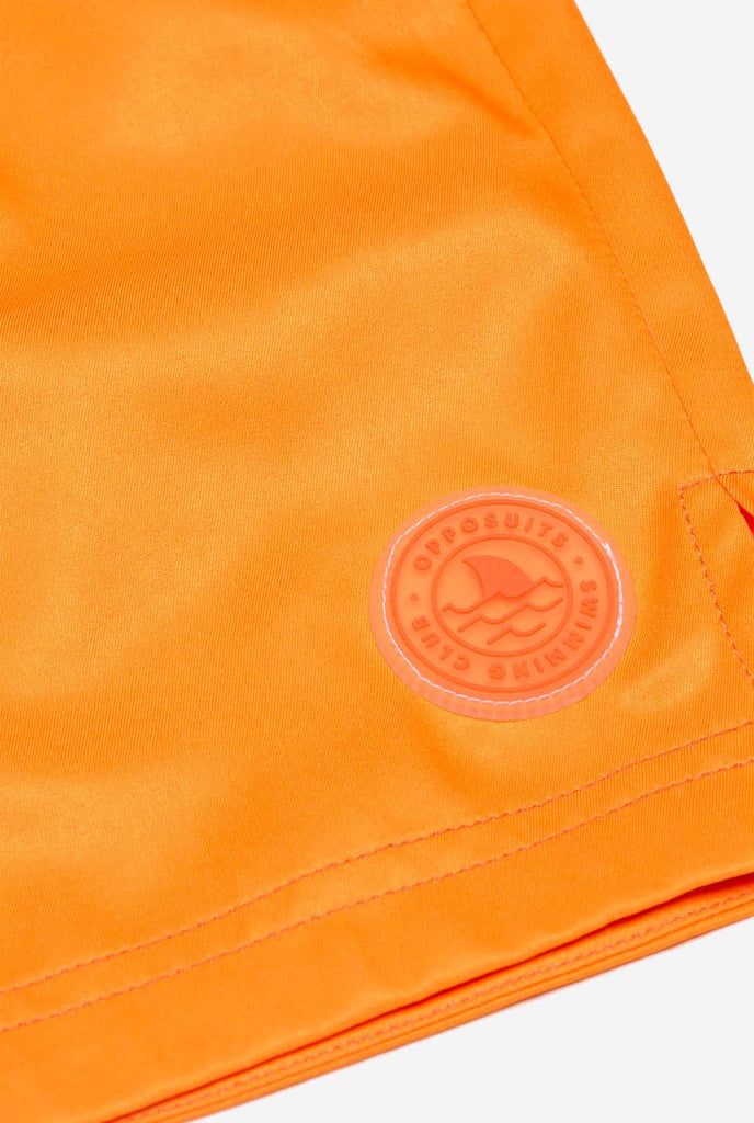 Man wearing Neon Vivid Orange swim trunks for men, close up