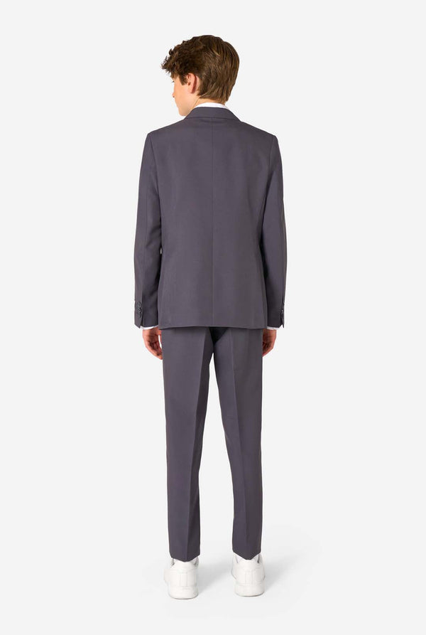 Een tienerjongen in een stijlvol antracietgrijs pak met een wit overhemd, vol zelfvertrouwen lachend. De perfecte formele outfit voor speciale gelegenheden, bruiloften en feestjes.