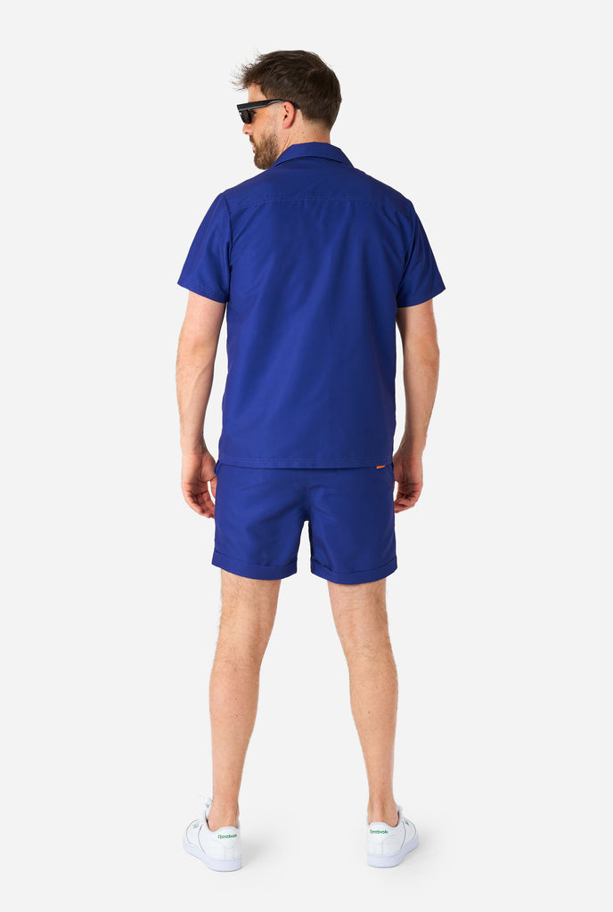 Man wearing blue summer set, consisting of shorts and shirt