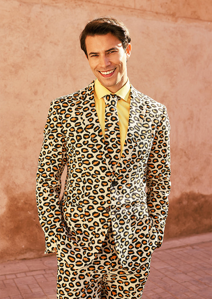 Man wearing men's suit with panther print and yellow shirt.