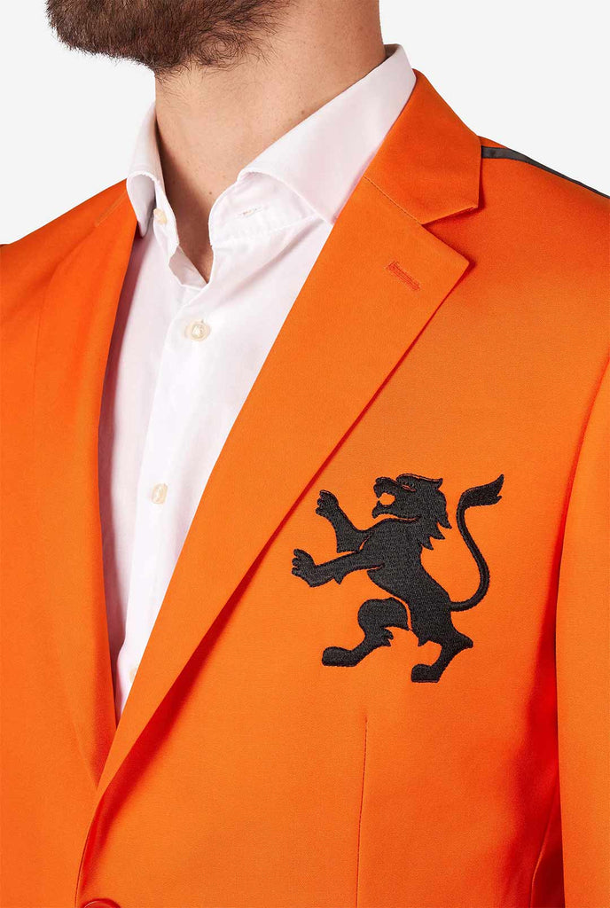 Man draagt ​​oranje blazer met Nederlandse leeuw, close -up