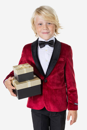 Jongen met een rood fluwelen kerstdiner jasje