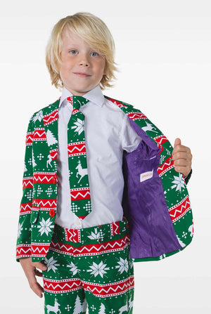 Kind draagt ​​groen kerstpak