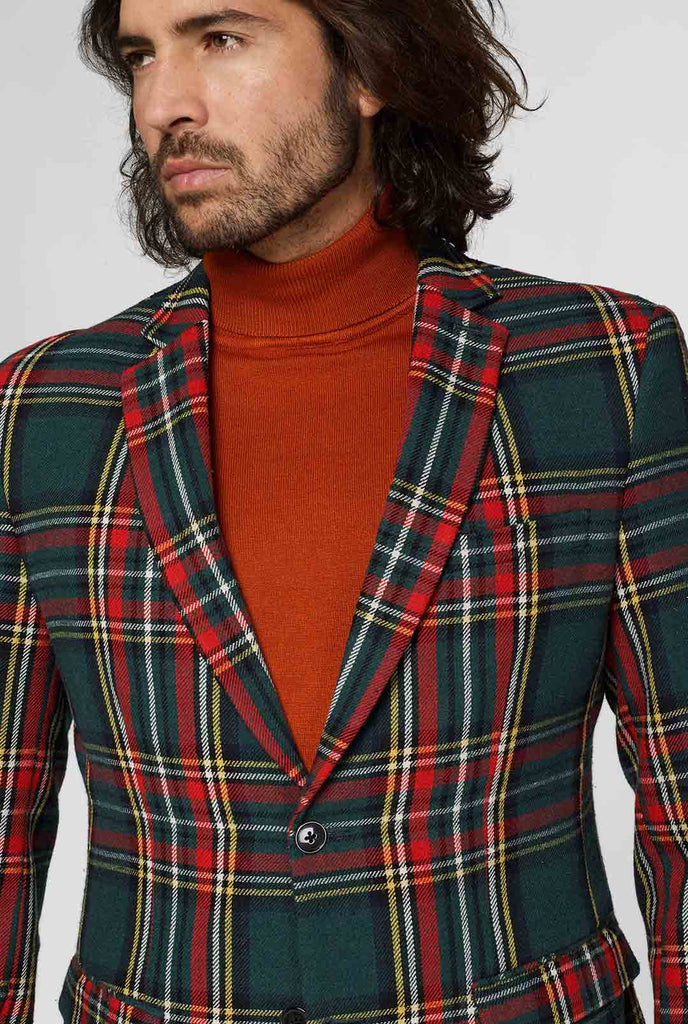 Rode en groene tartan blazer gedragen door de mens, close -up