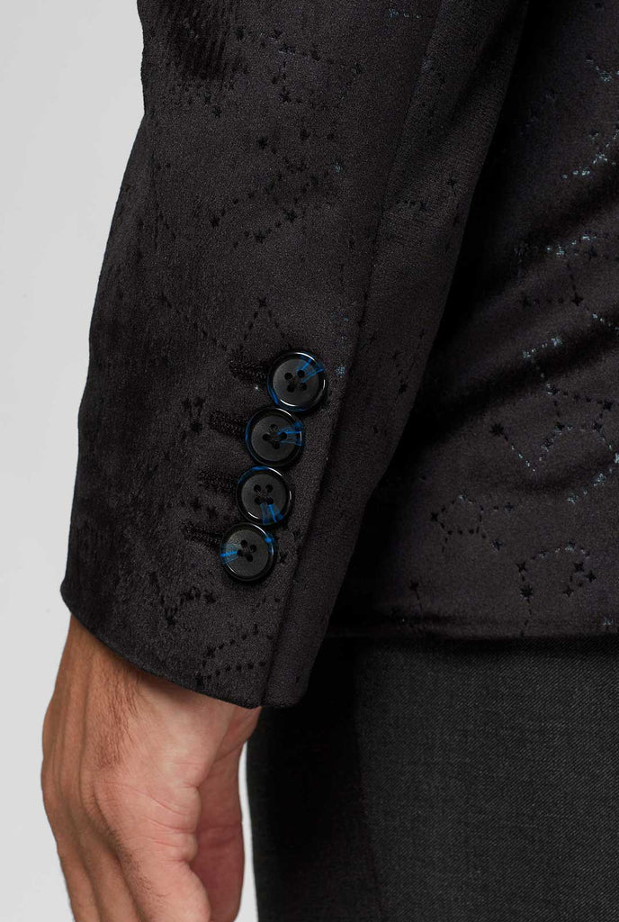 Zwart jas met sterrenbeeldpatroon close -up van mouw