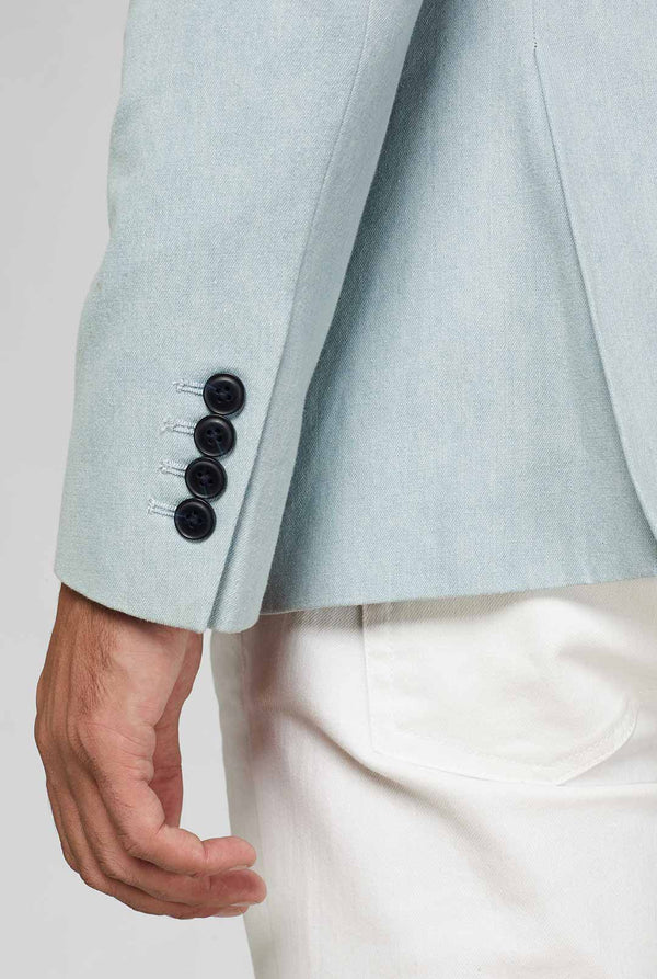Blauwe blazer met witte en roze bliksemschichthuls van dichtbij