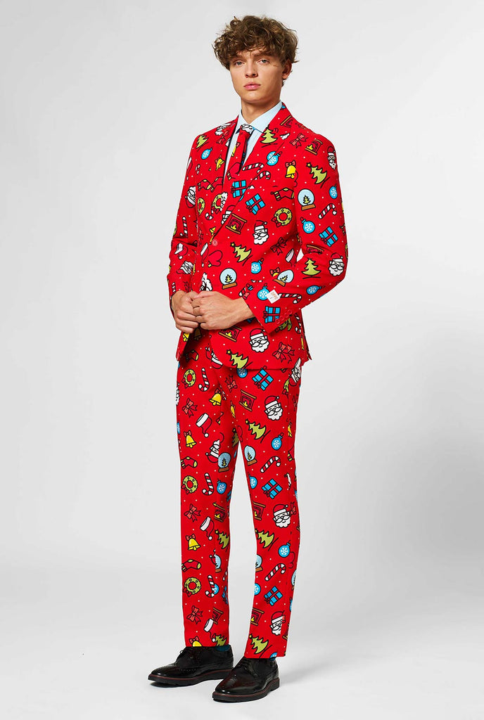 Rood kerstpak met kerstpictogrammen gedragen door de mens