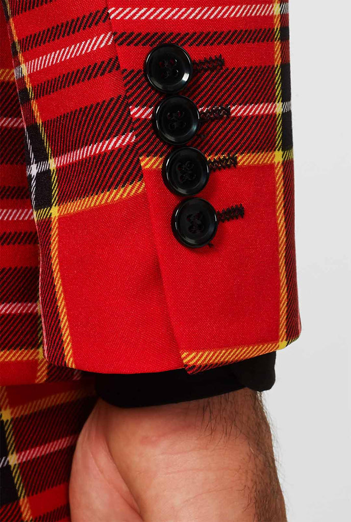 Man draagt ​​rood kersttartan herenpak, mouw close -up