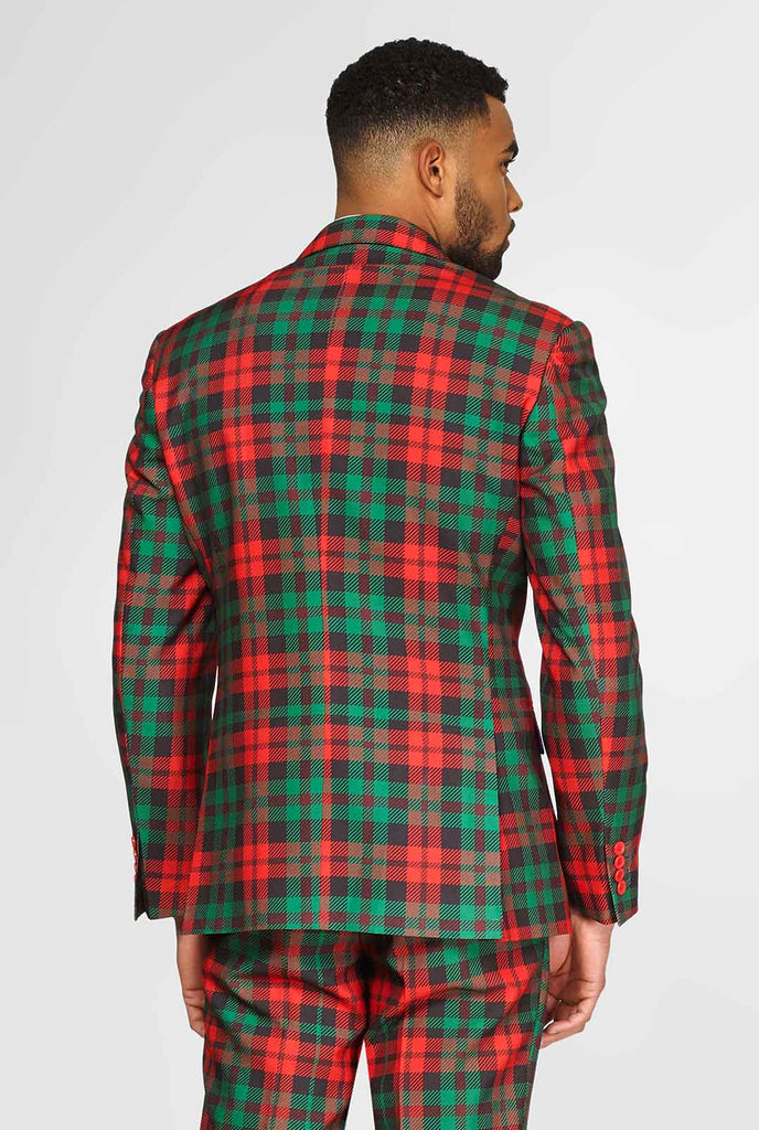 Groene en rode tartan kerstmerenpak gedragen door de mens, uitzicht vanaf de achterkant