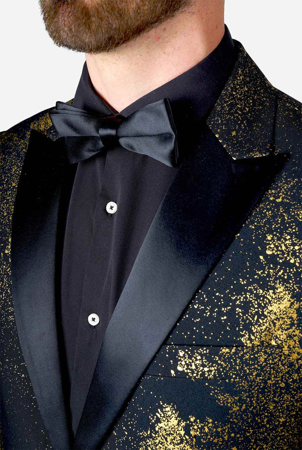 Man draagt ​​zwarte blazer met gouden kerstboomprint, close -up