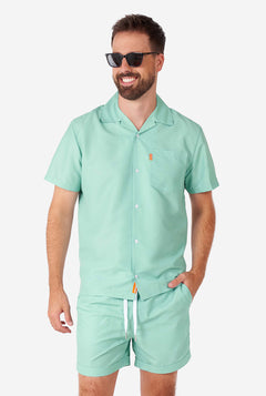 Man draagt ​​een groene zomerset, bestaande uit shirt en shorts met korte mouwen.