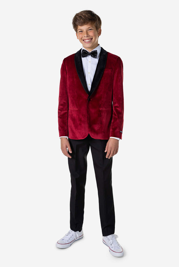 Tiener met een rood fluwelen kerstdiner jasje