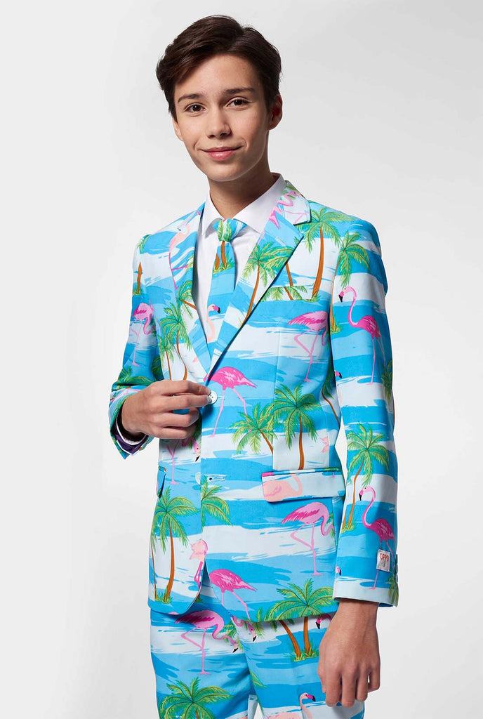 Tiener draagt ​​een lichtblauw pak met flamingo palmboomprint
