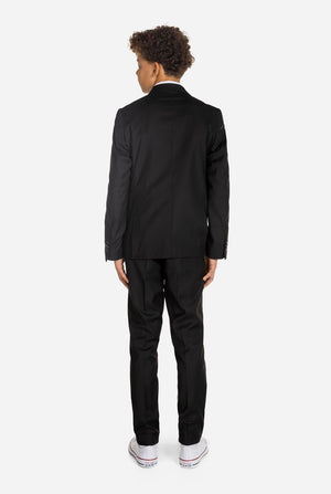 Tiener draagt ​​OppoSuits Daily Zwart tiener jongenspak, zicht vanaf de achterkant