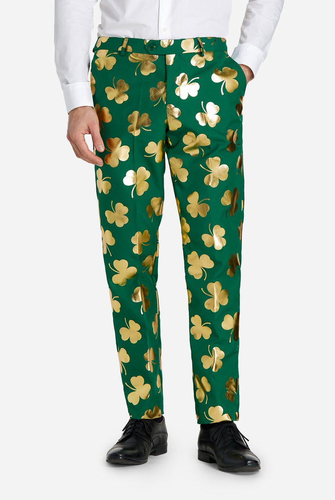 Man wearing green St Patrick's Day suit with golden clovers, pants view.